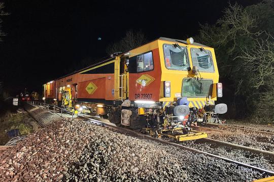 Ballast tamping machine in action. (Courtesy Network Rail)